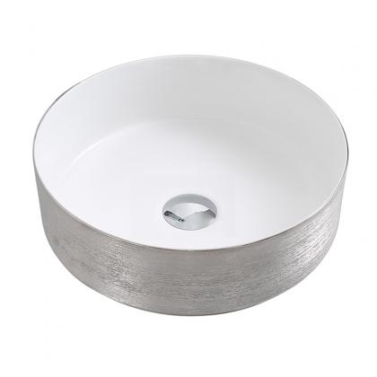 Small round brushed silvery countertop basin